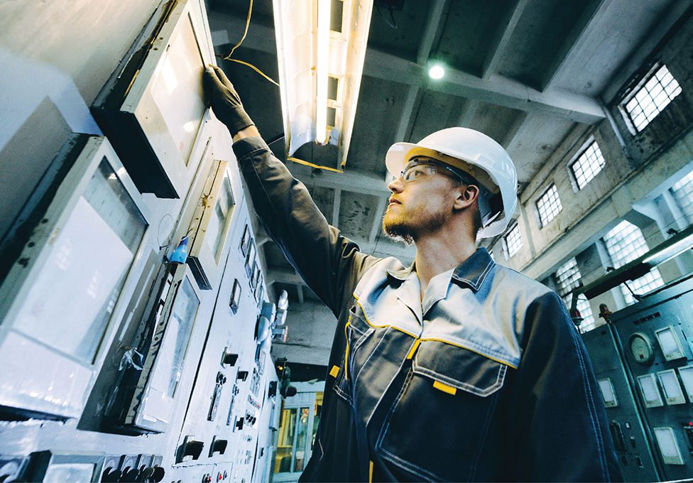 facility worker powering down equipment